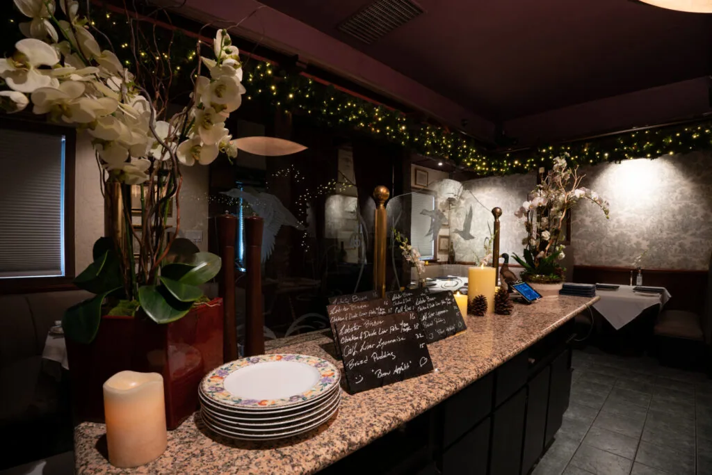The candlelit front room and bar at Le Sanglier